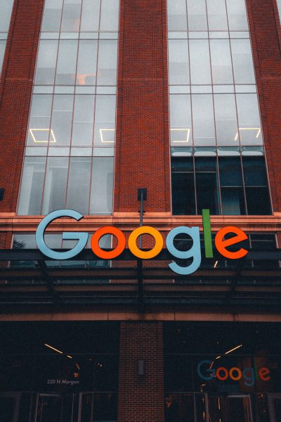 Colorful Google logo on modern building exterior in urban environment.